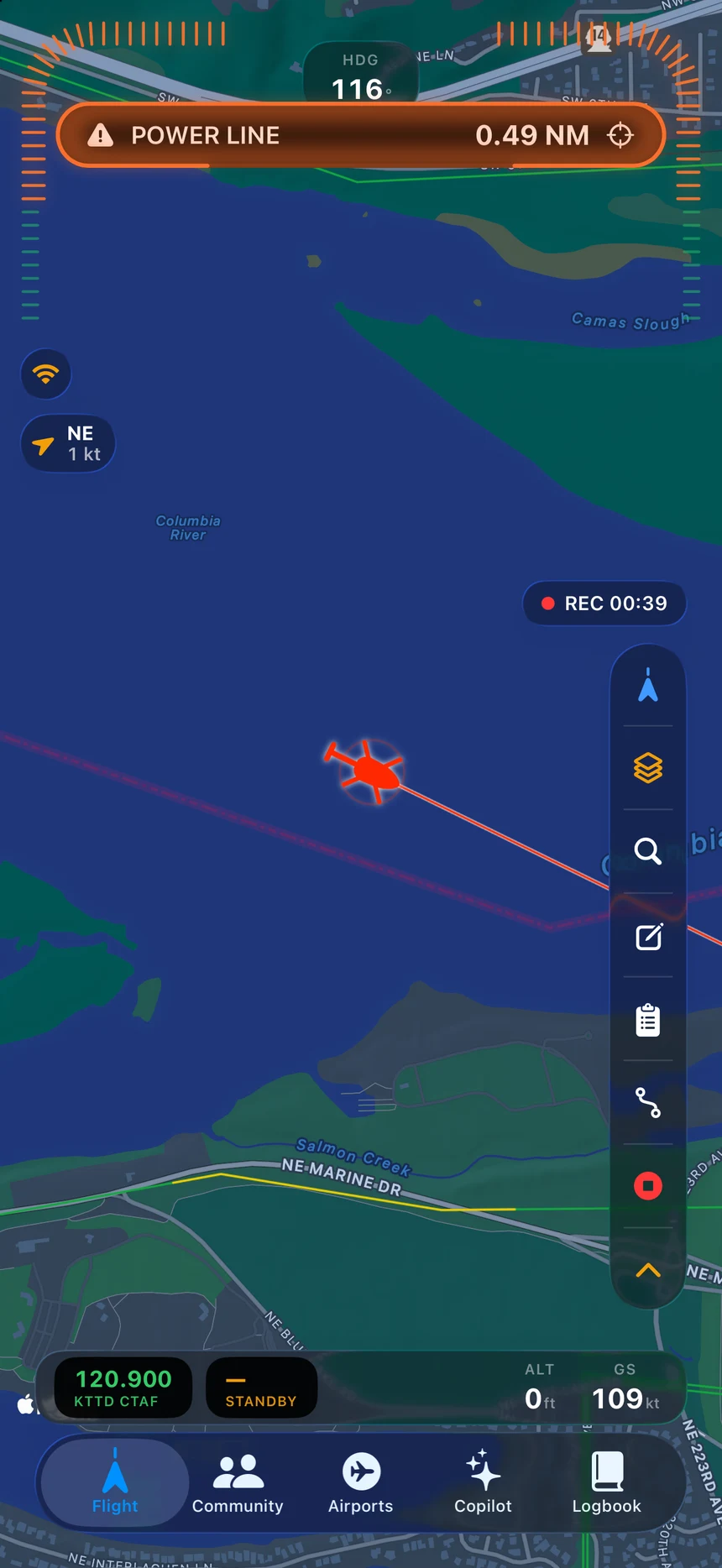 A live POWER LINE alert on the FLYT map at 0.49 nautical miles: the ownship turns red, the span ahead is highlighted, and the alert arc lights on the side the hazard is on.